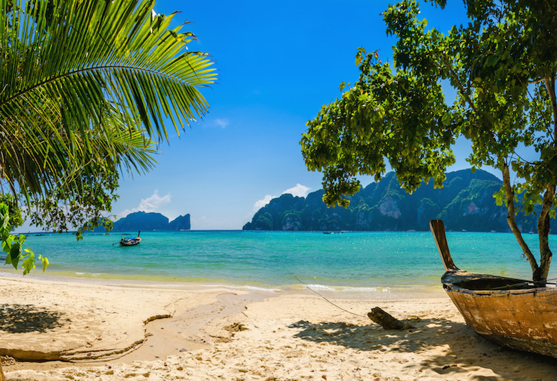 Exotic beach with palms and boats on azure water, Phi Phi Island, Phuket area, Thailand
