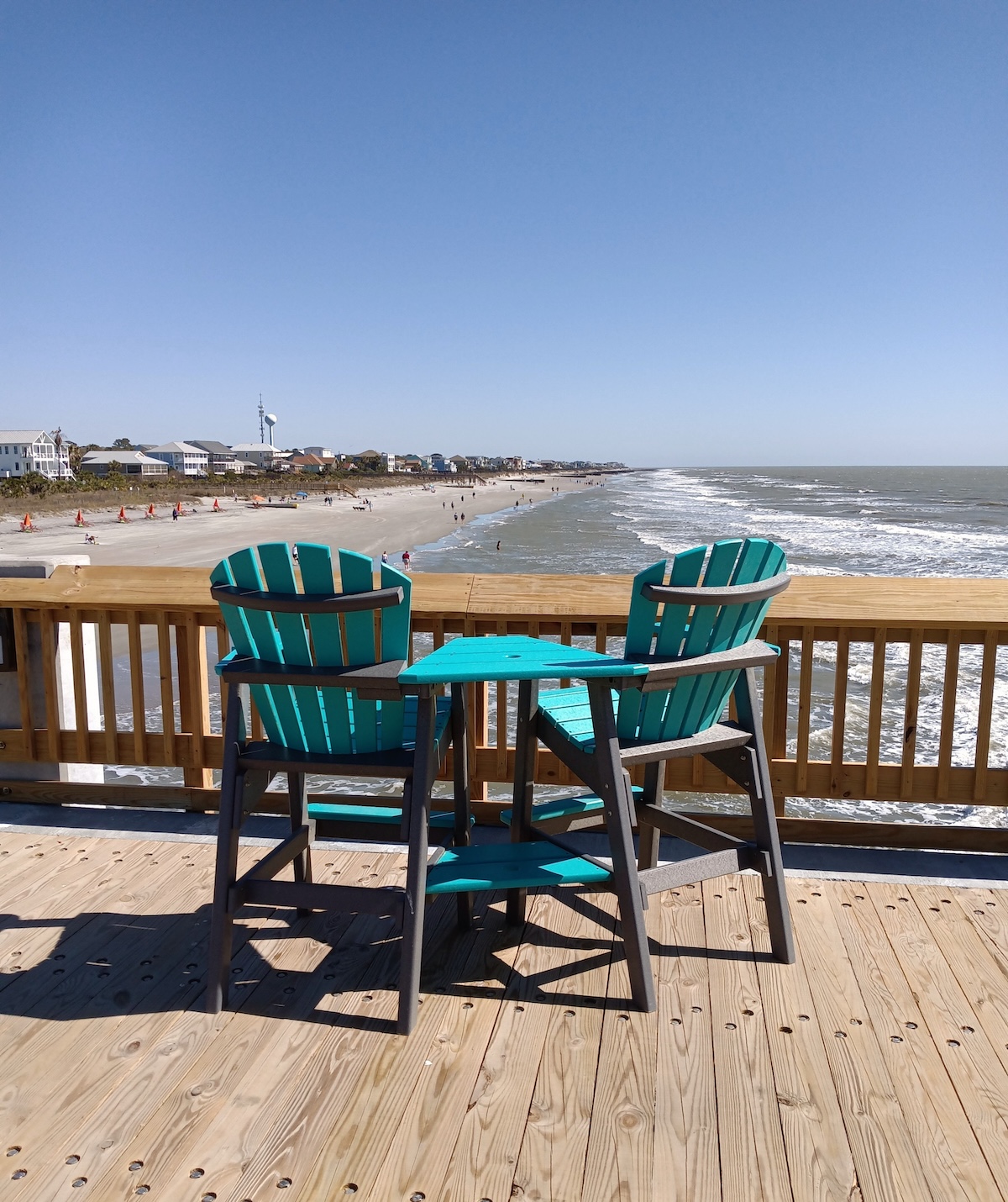 Chairs and table on the pier at Folly Beach, SC